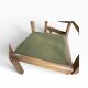 Vintage wooden chair with olive green seat and armrests.