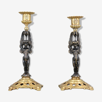 Pair of candle holders in gilded bronze and patinated with a candle