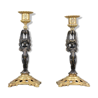 Pair of candle holders in gilded bronze and patinated with a candle