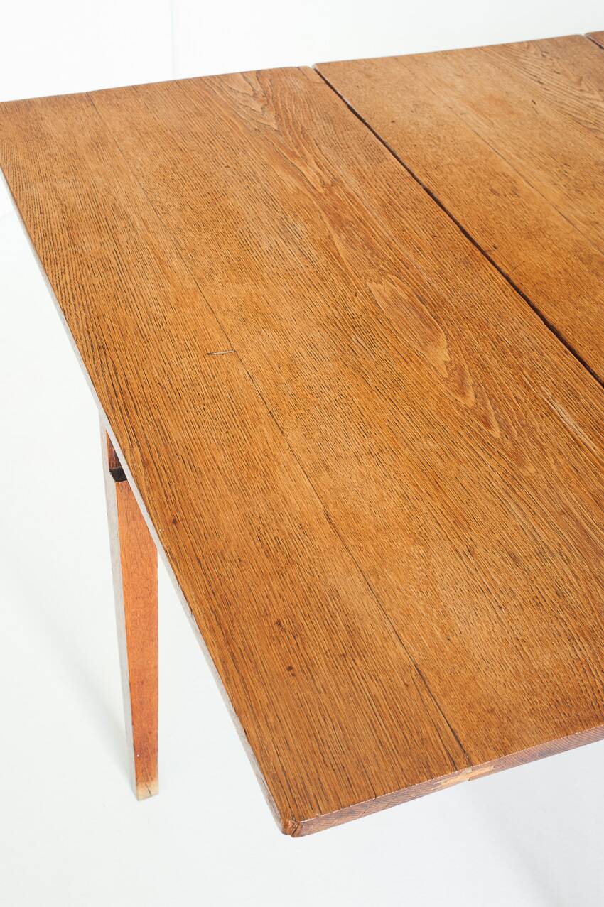 Vintage table with two folding leaves. Solid oak wood. France, 1940s