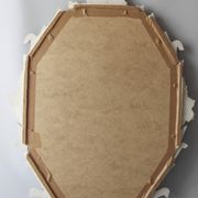 Antique oval mirror carved in wood.