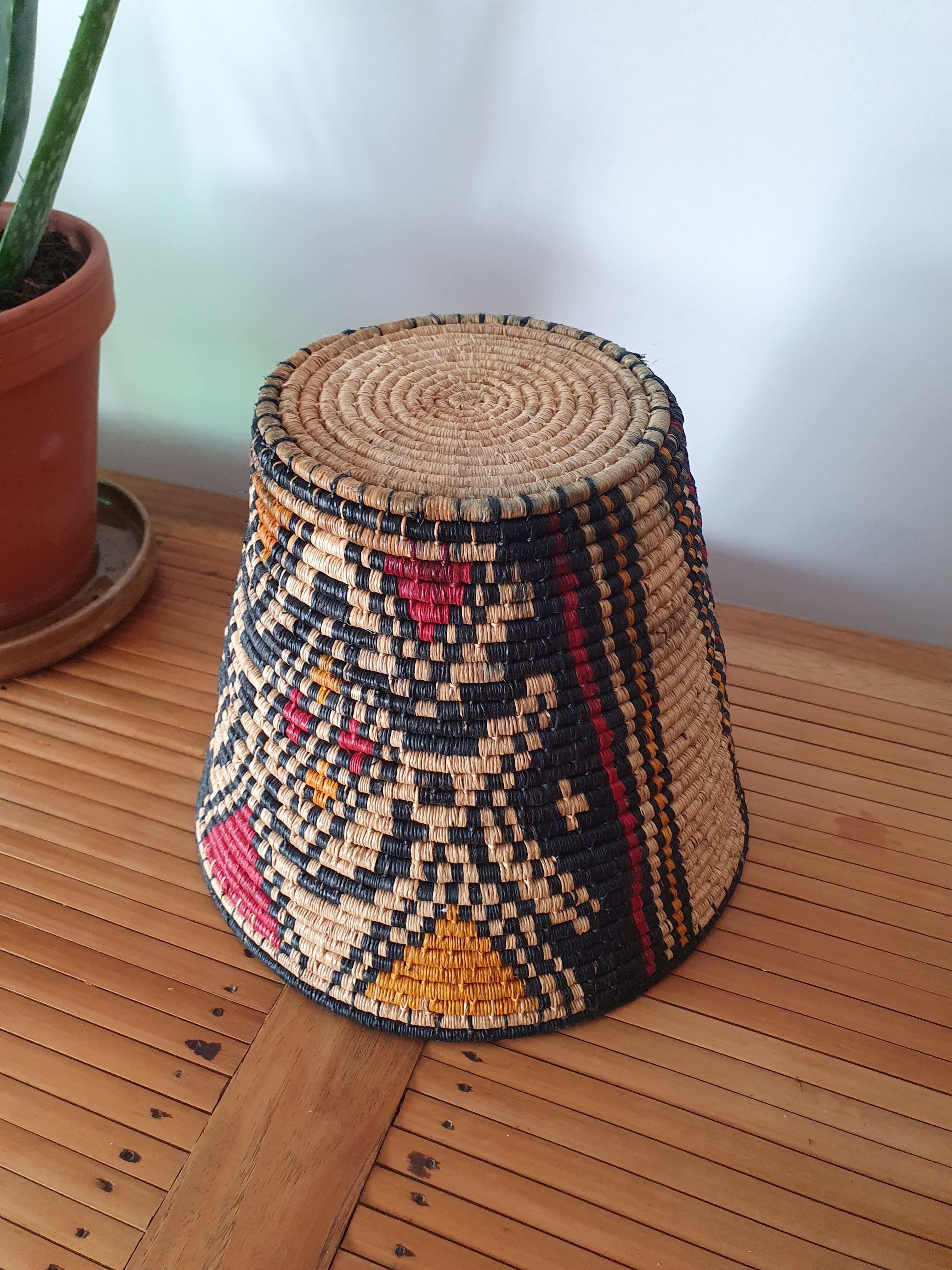 Ethnic basket in multicolored braided straw