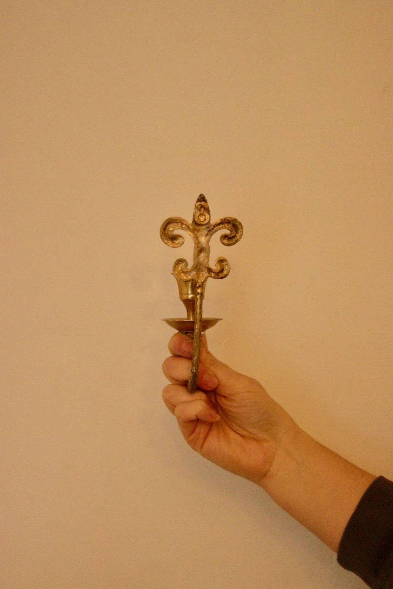 A pair of antique brass wall sconces.