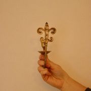 A pair of antique brass wall sconces.