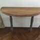 Antique painted wooden half-moon console table
