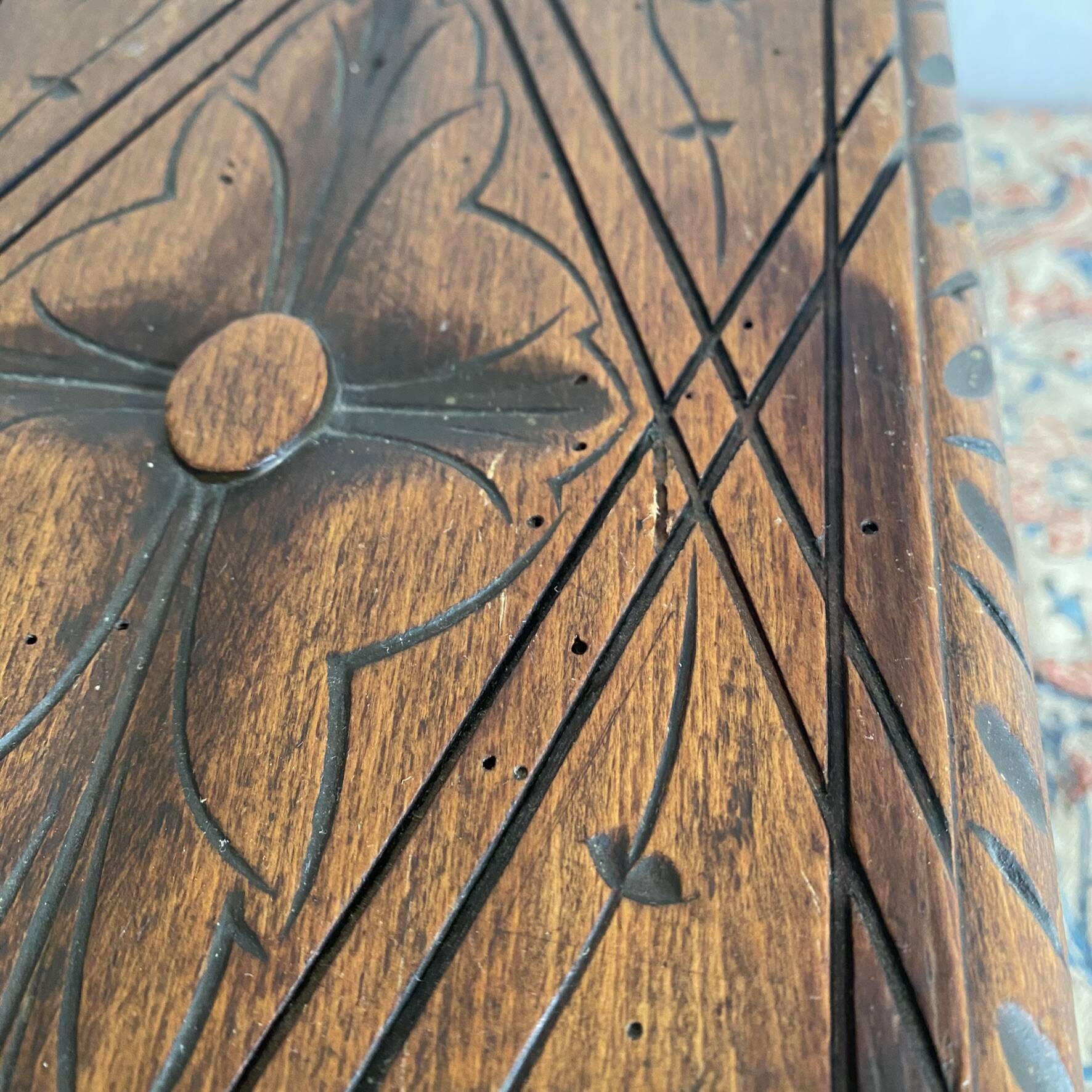 Low stool in carved wood