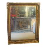 Old mirror with gilded leaves and flowers carved on top of it 1800s
