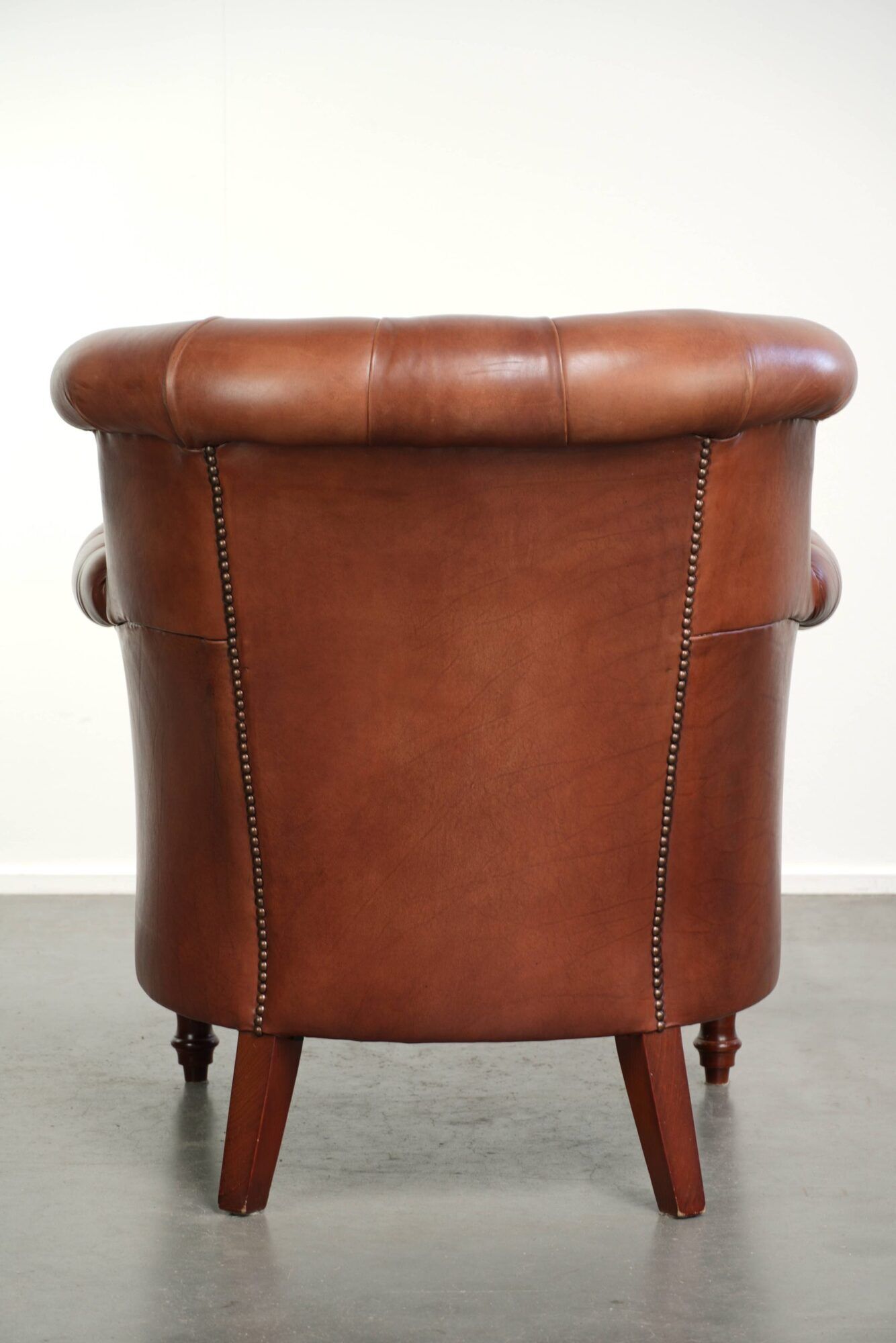 Cognac-coloured cow leather Chesterfield armchair in English style