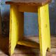 Art-populaire workshop stool in patinated wood