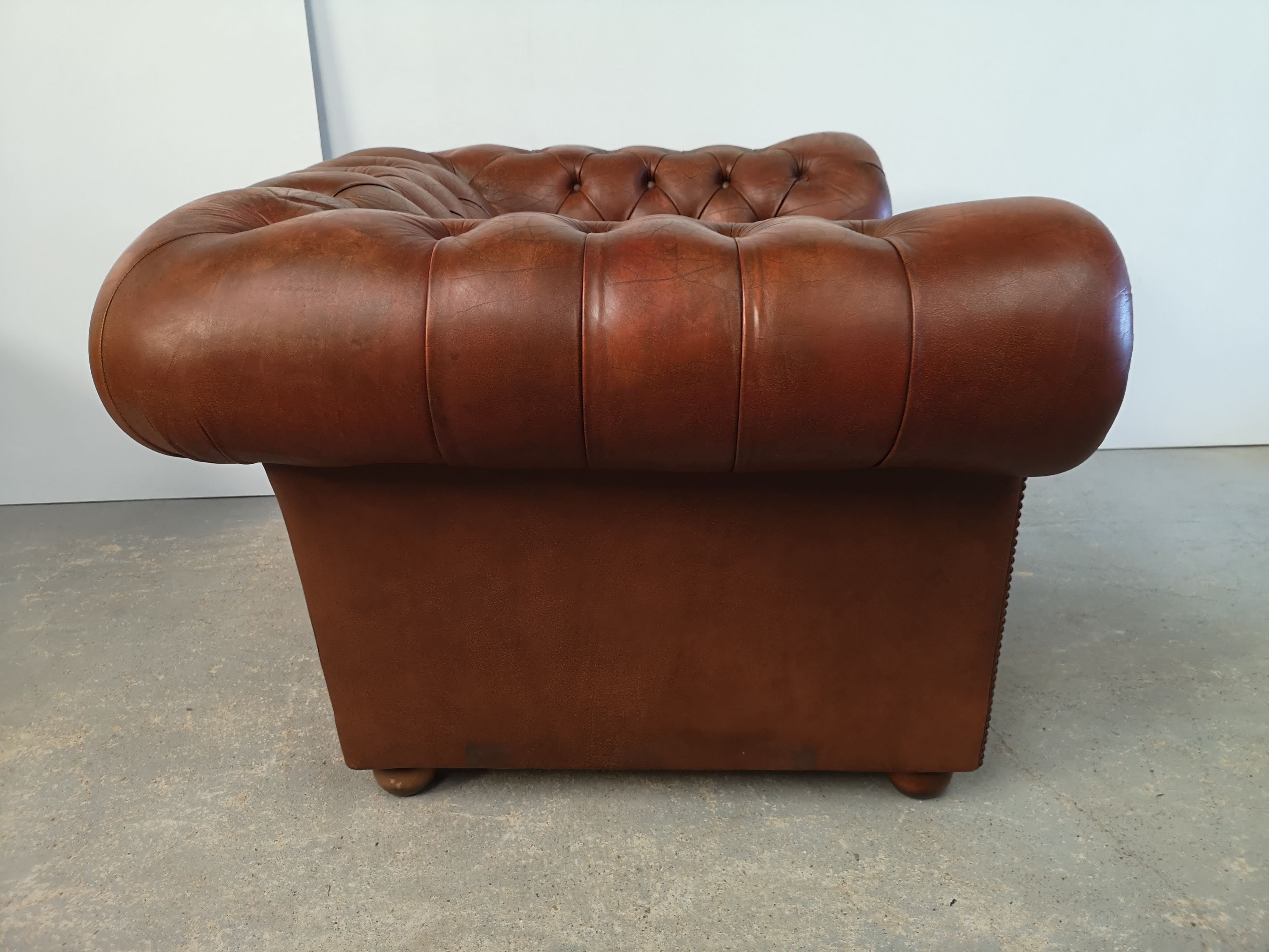 Brown leather chesterfield armchair