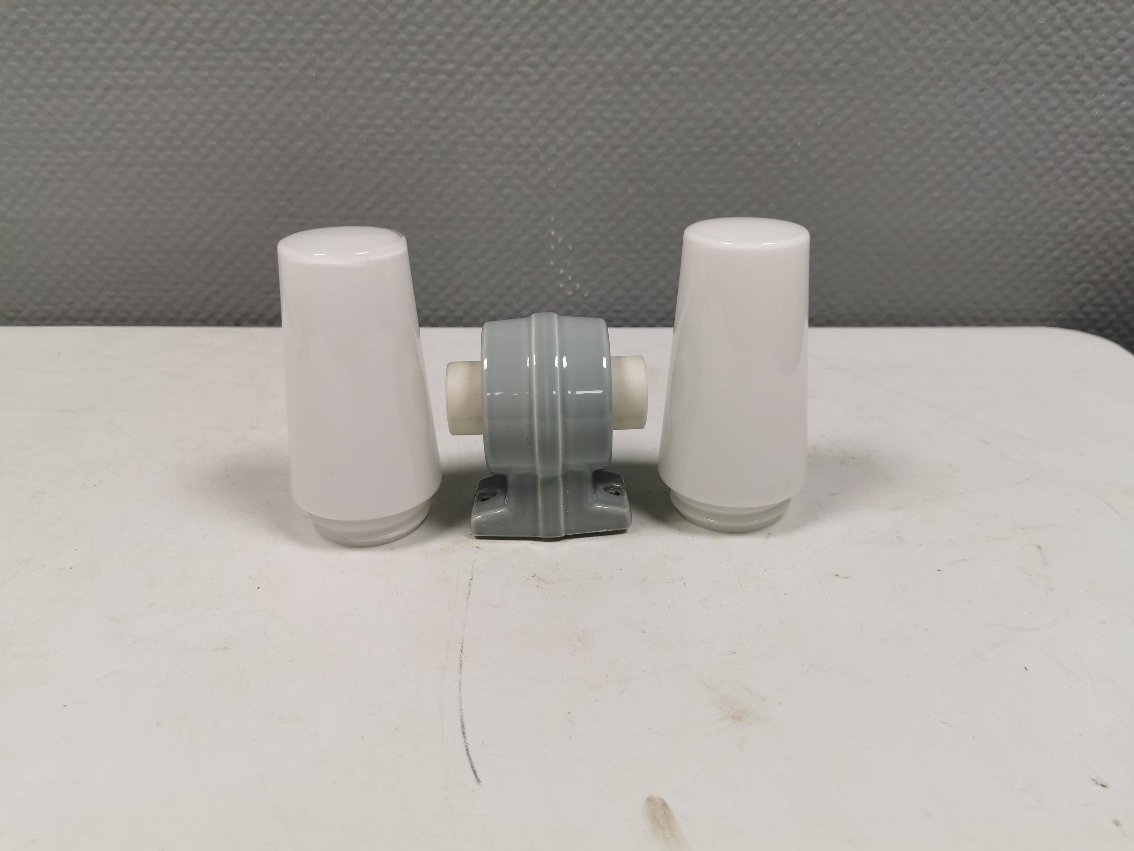 Bathroom lamp with light gray ceramic base,  and milky white opal glass.