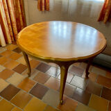 Round extendable wooden table with glass top