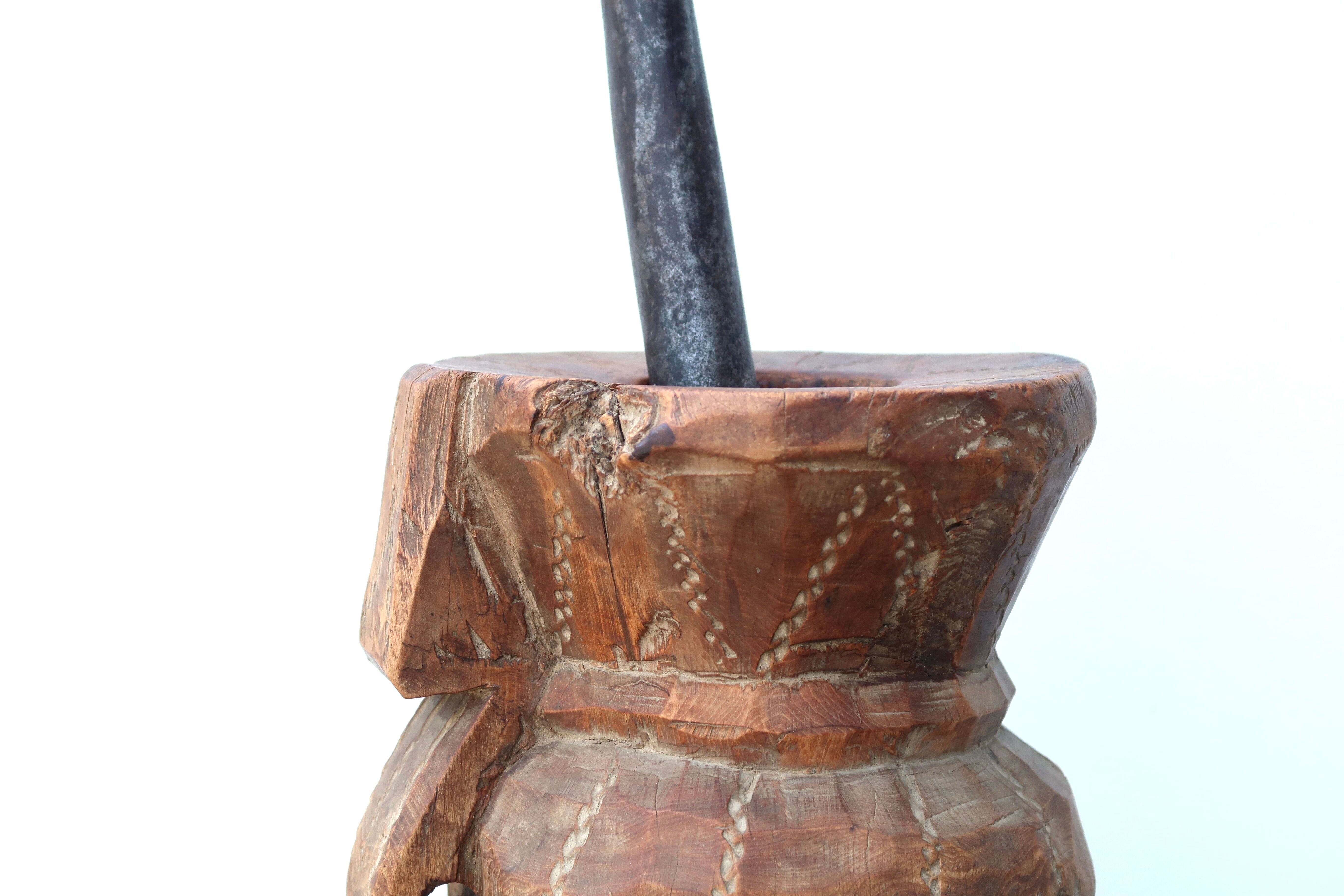 African mortar in carved wood, cast iron pestle, 70s