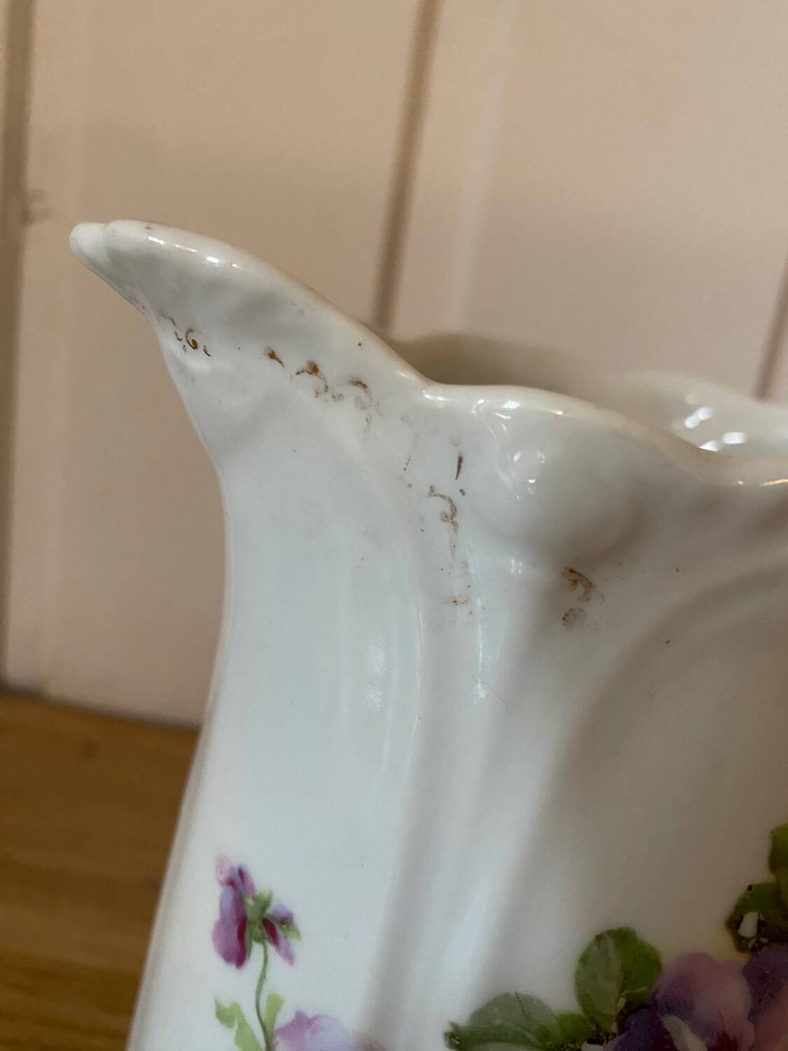 Old ceramic pitcher decorated with flowers