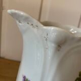 Old ceramic pitcher decorated with flowers