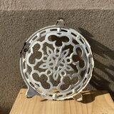 Old trivet in enameled cast iron round format white vintage tableware