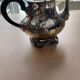 Teapot and sugar bowl in silver-plated metal.