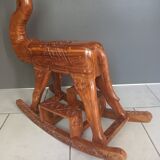 Decorative rocking elephant in carved exotic wood.