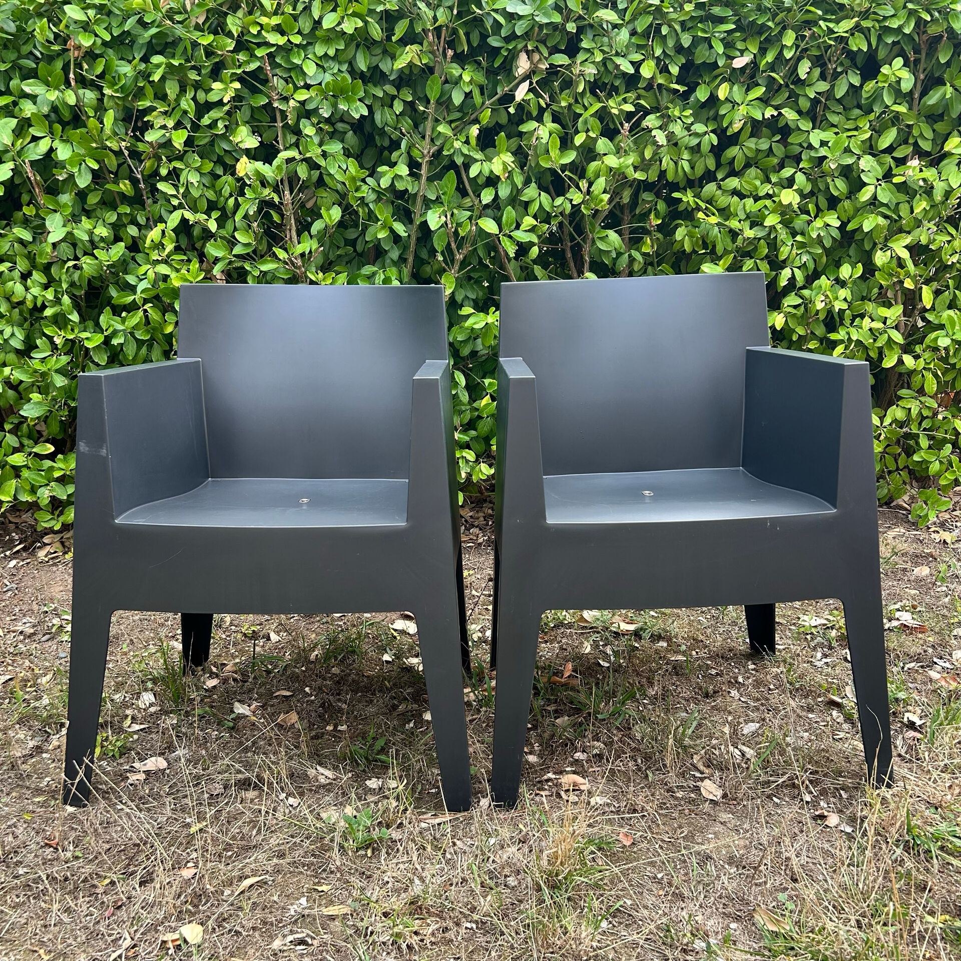 2 black Toy chairs designed by Starck