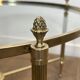 Neoclassical Round Coffee Table in Brass with Fluted Supports and Floral Motifs