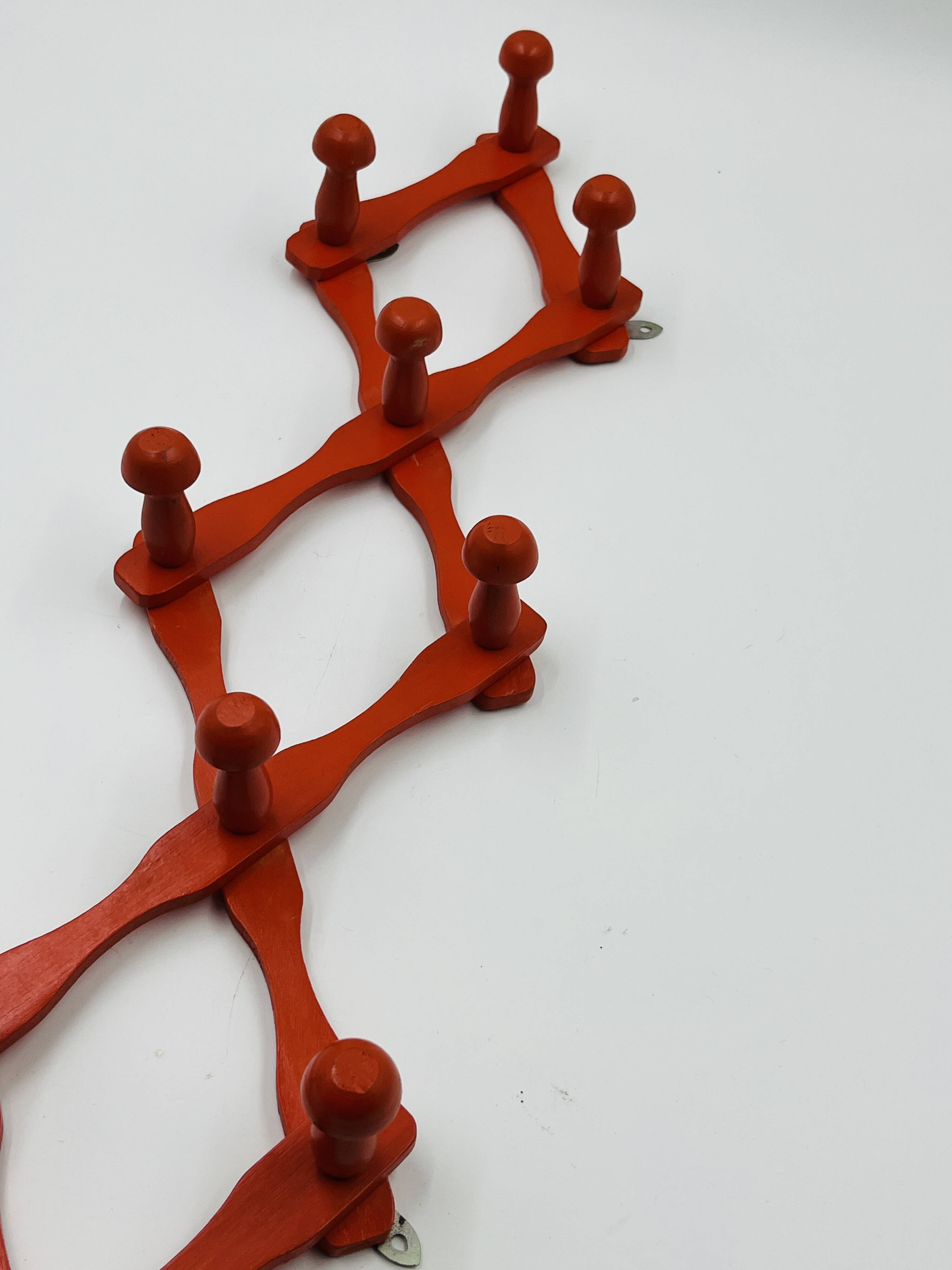 Vintage orange accordion coat rack