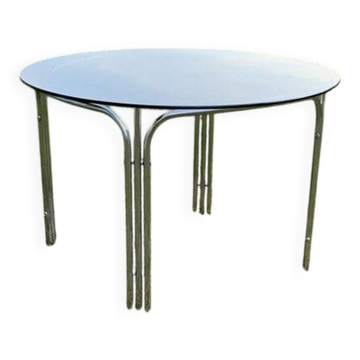 Mid-century round coffee table with chrome and silver glass top from the 1960s.