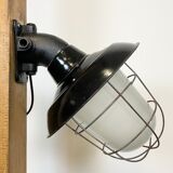 Industrial black enamel and cast iron wall lamp with iron grid, 1960s