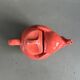 Large coral-coloured elephant teapot.