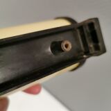 Old wall lamp, made of bakelite with a vanilla/egg colored glass shade.