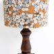 Vintage turned wood table lamp with floral drum shade.