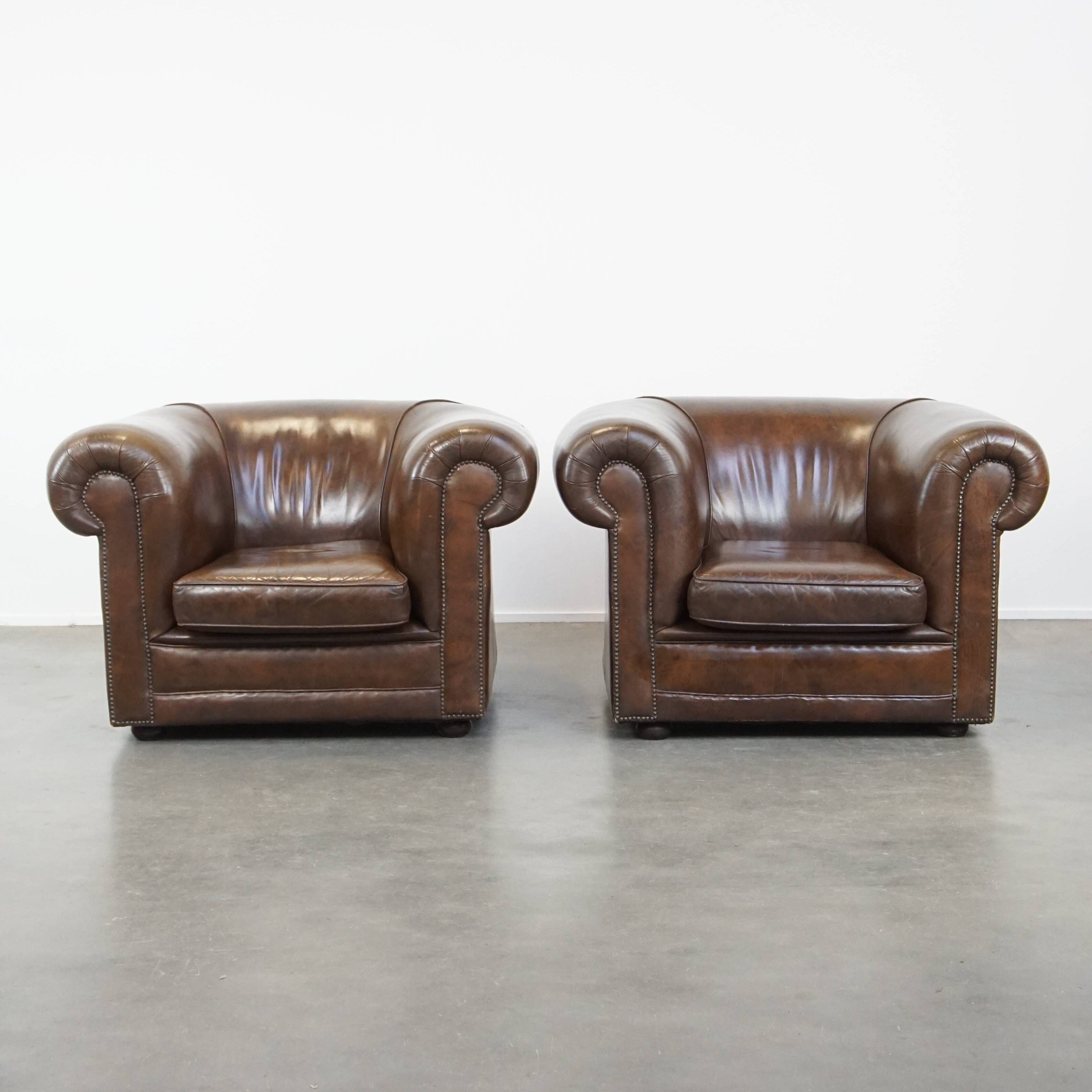 2 Chesterfield armchairs in dark brown cowhide