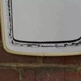 Rearview mirror and screen-printed with gold outline and black edging
