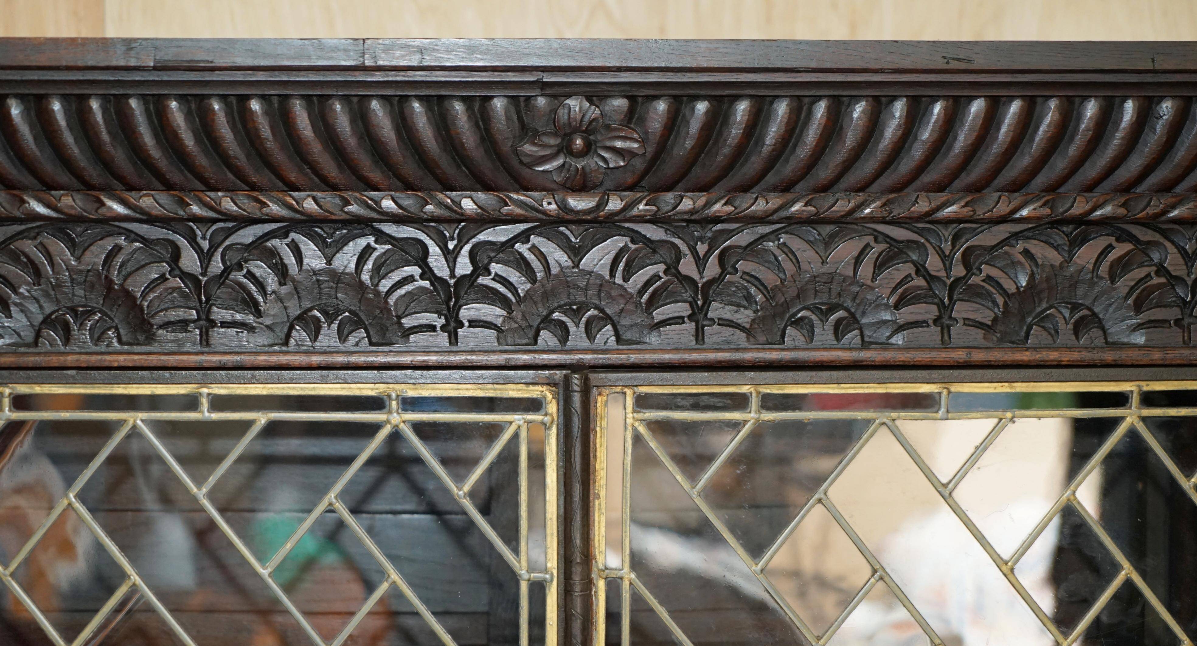 Jacobean hardwood library with carved panels and glass doors.