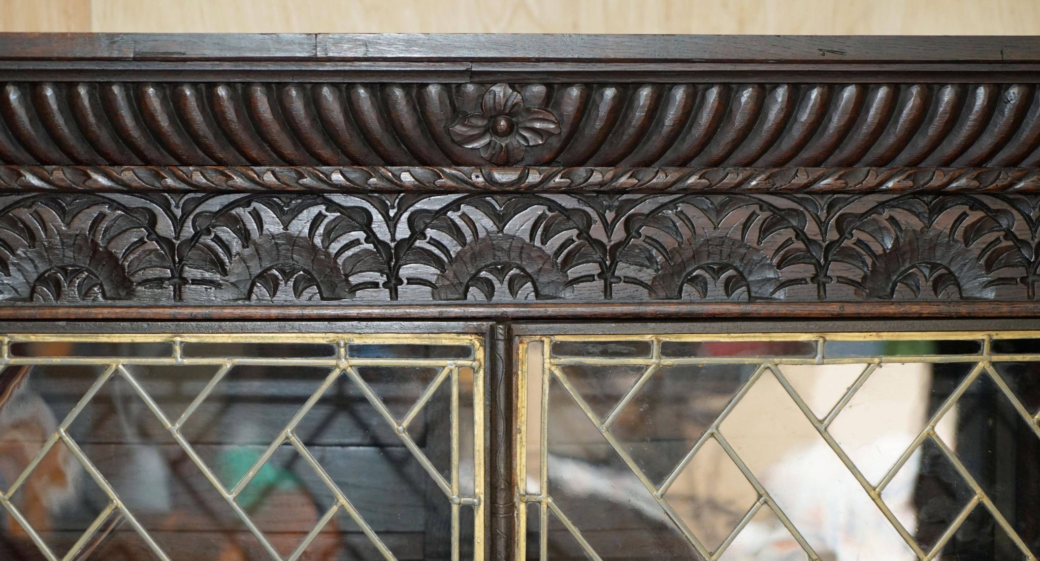 Jacobean hardwood library with carved panels and glass doors.