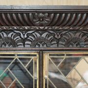 Jacobean hardwood library with carved panels and glass doors.