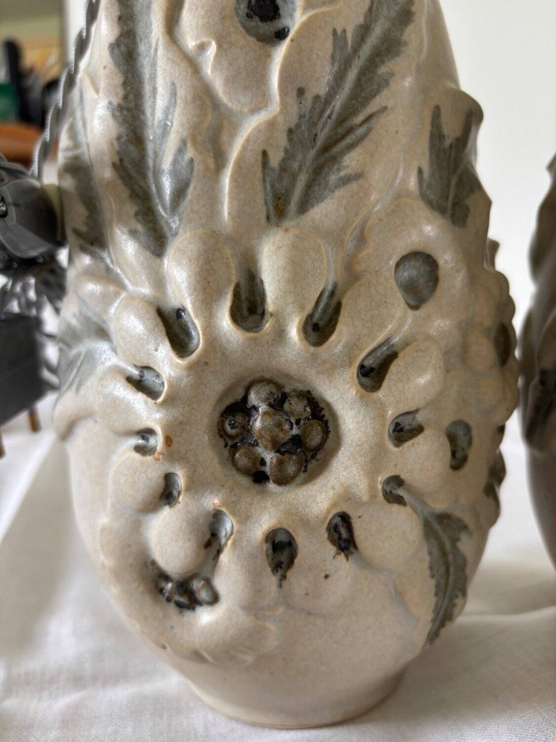 Pair of white glazed stoneware lamp bases, 20th-century floral decoration.