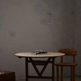 19th-century French round wine table with an adjustable top and floral textile surface.