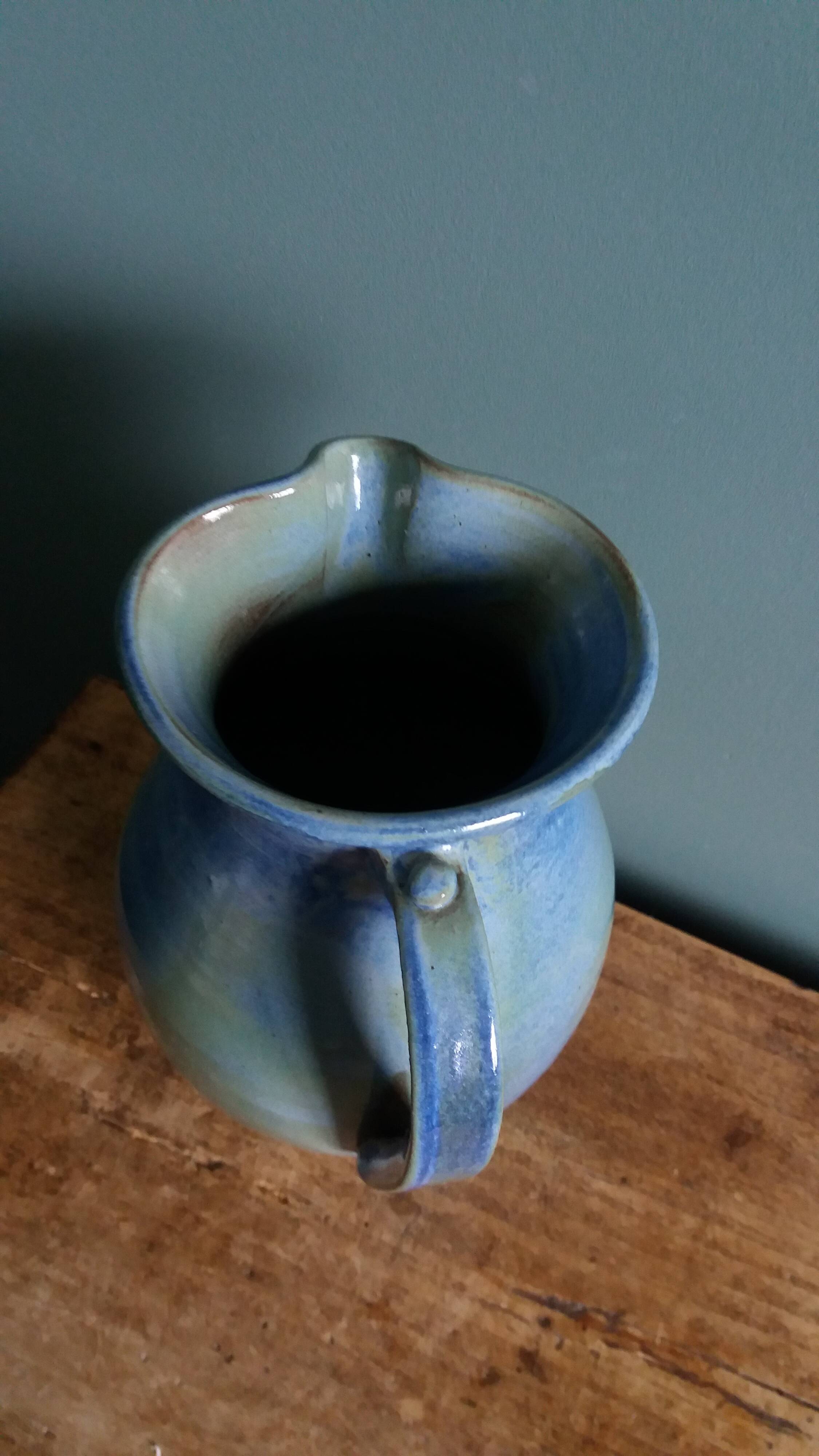 Enamel pitcher in pastel blue and green, signed