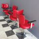 Quatre chaises de barbier en cuir rouge des années 1960 avec accoudoirs bakelite