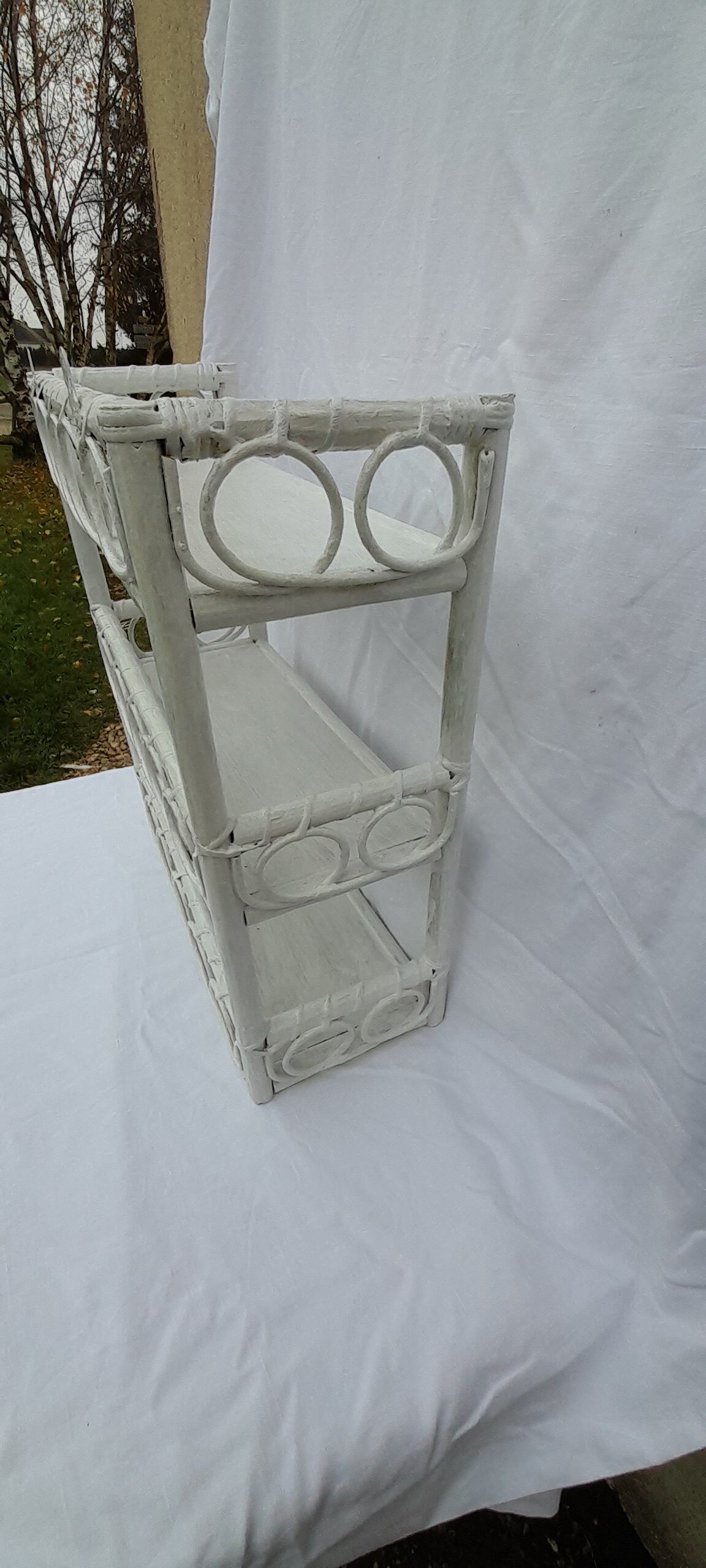 White rattan wall shelf
