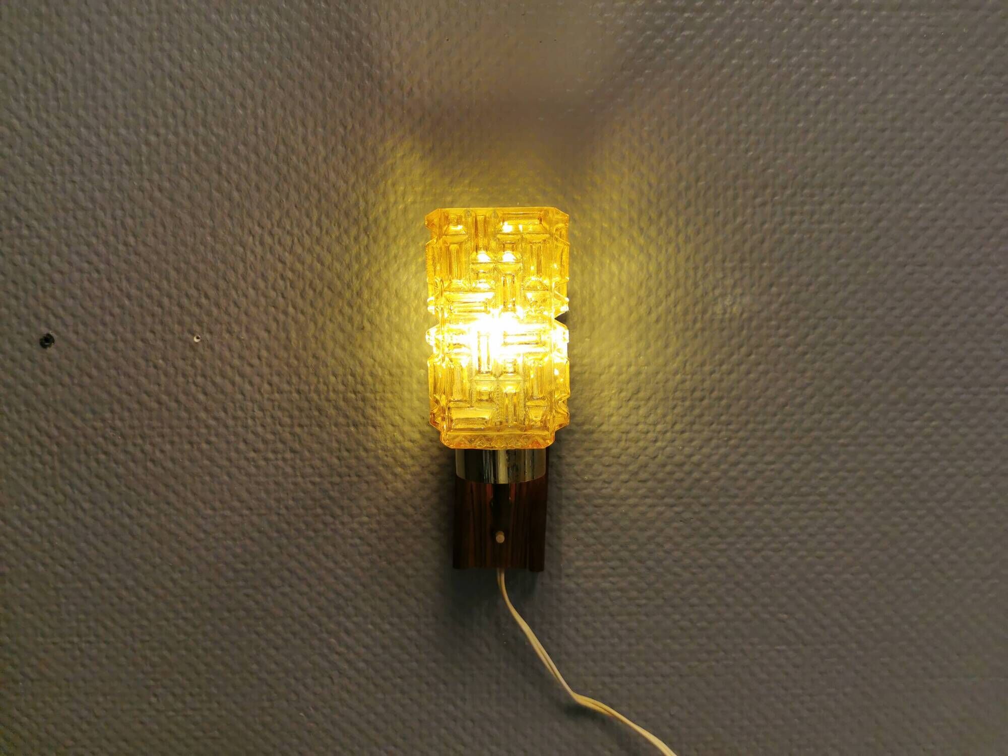 wall lights in rosewood look, with amber coloured glass and brass details.