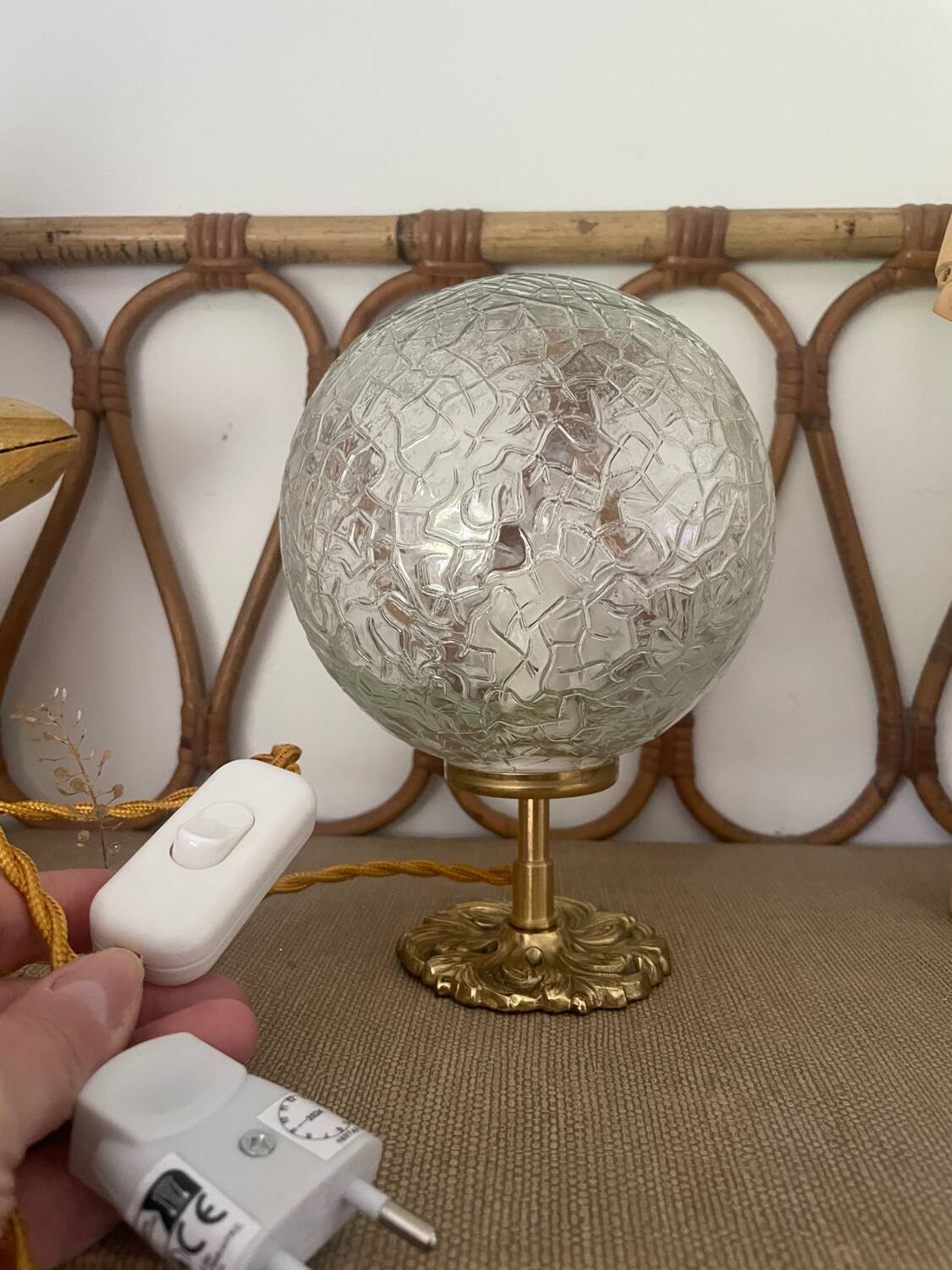 Small handcrafted globe lamp with a cracked finish and a golden brass base.