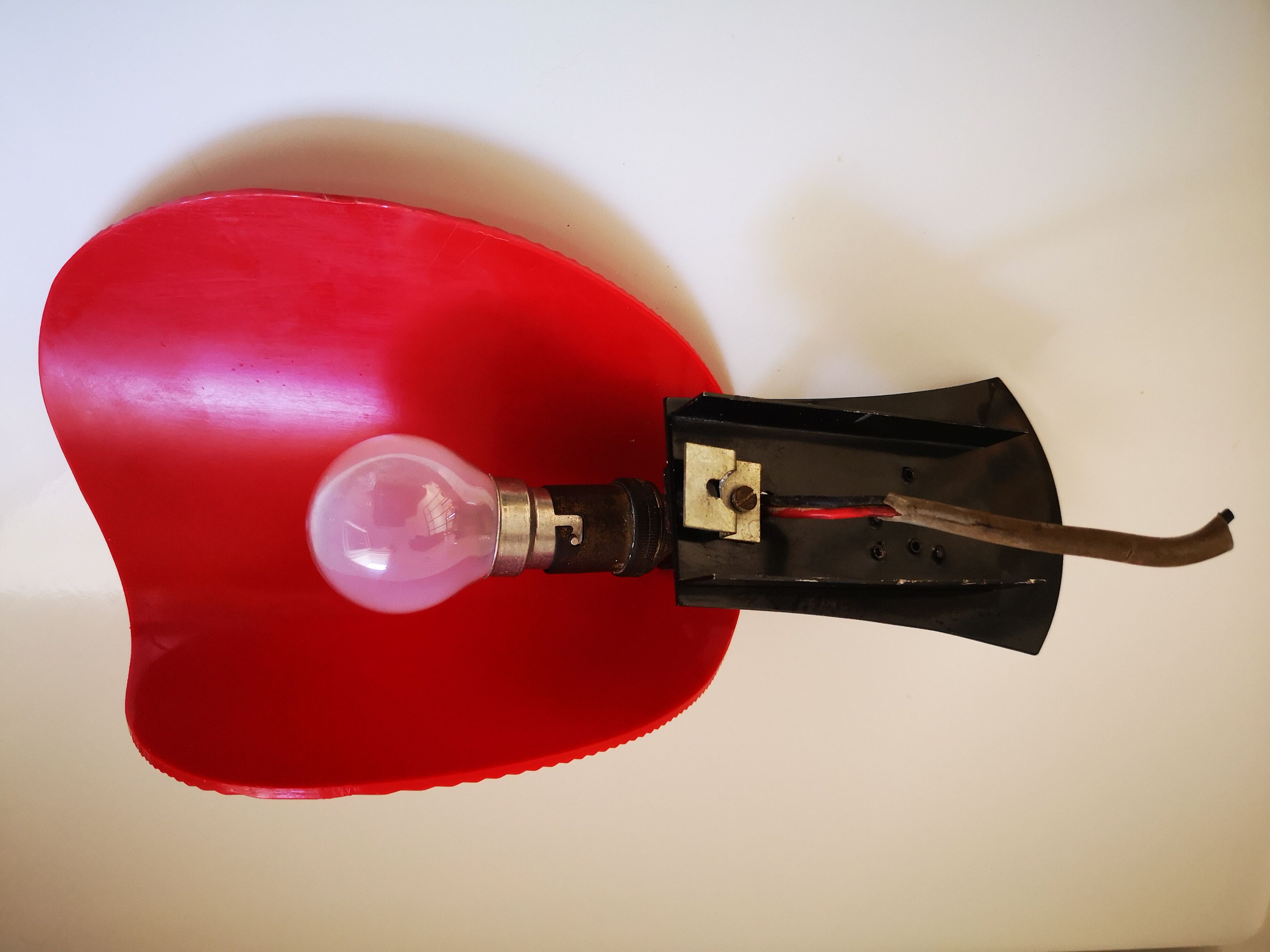 Red and black vintage sconce in fluted plastic and brass