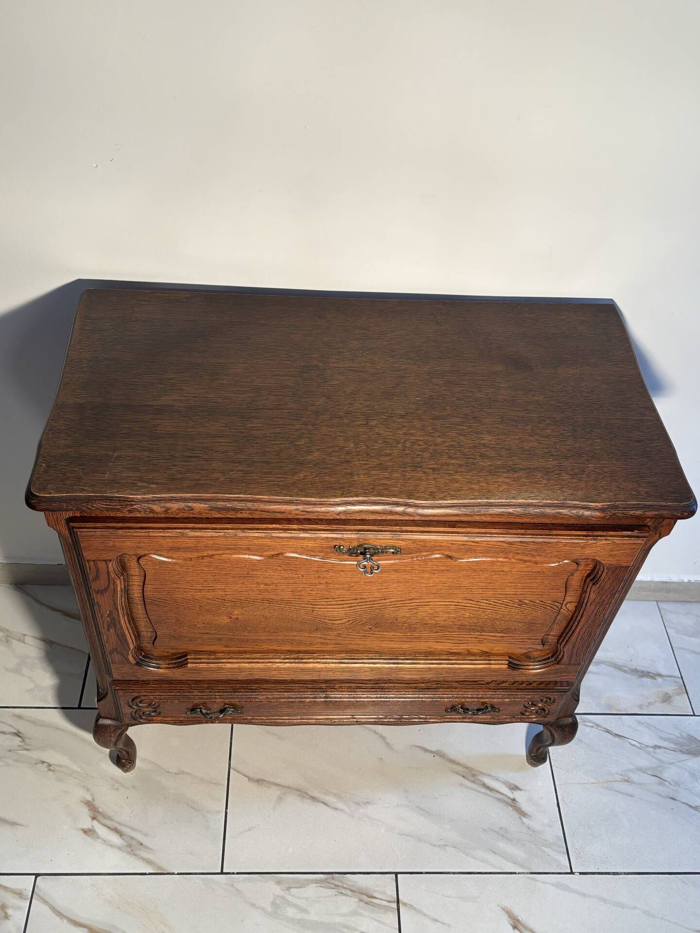 Louis XV style oak TV cabinet with drop-down flap.