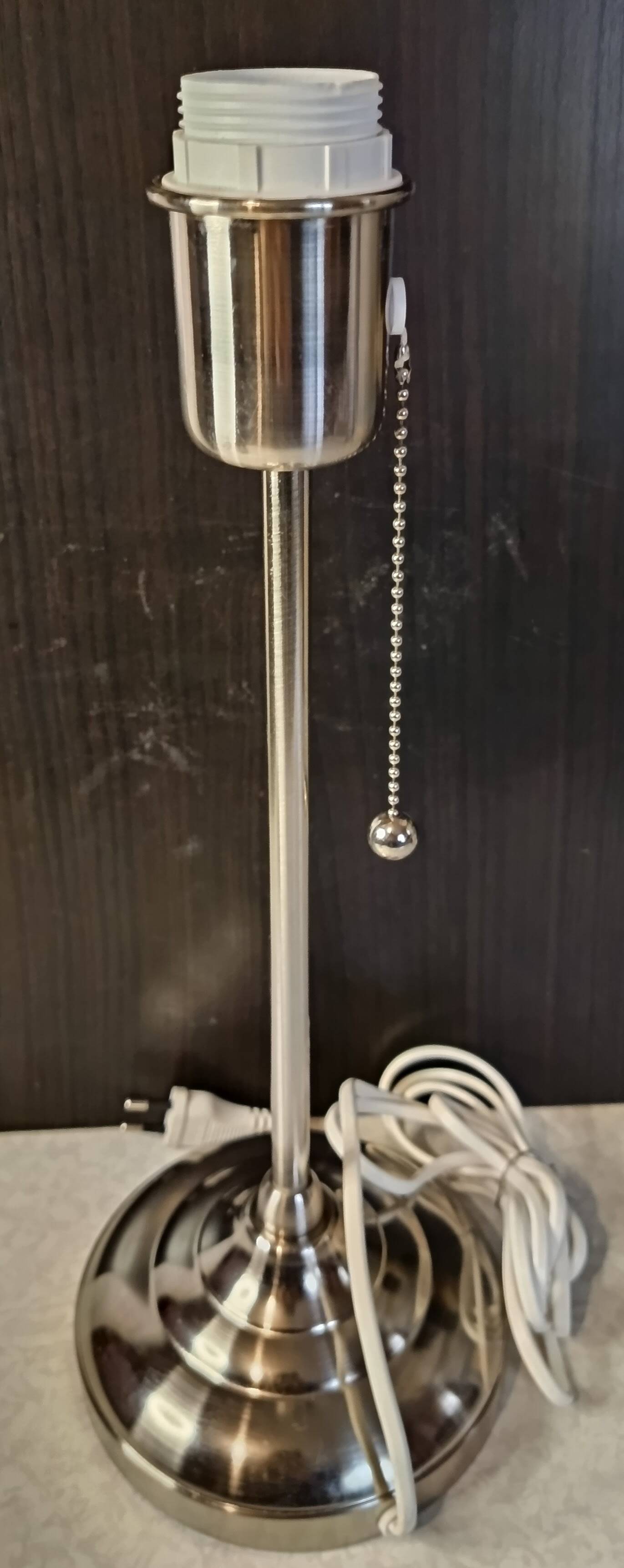 Modern white nickel lamp base with pull switch.