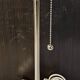 Modern white nickel lamp base with pull switch.