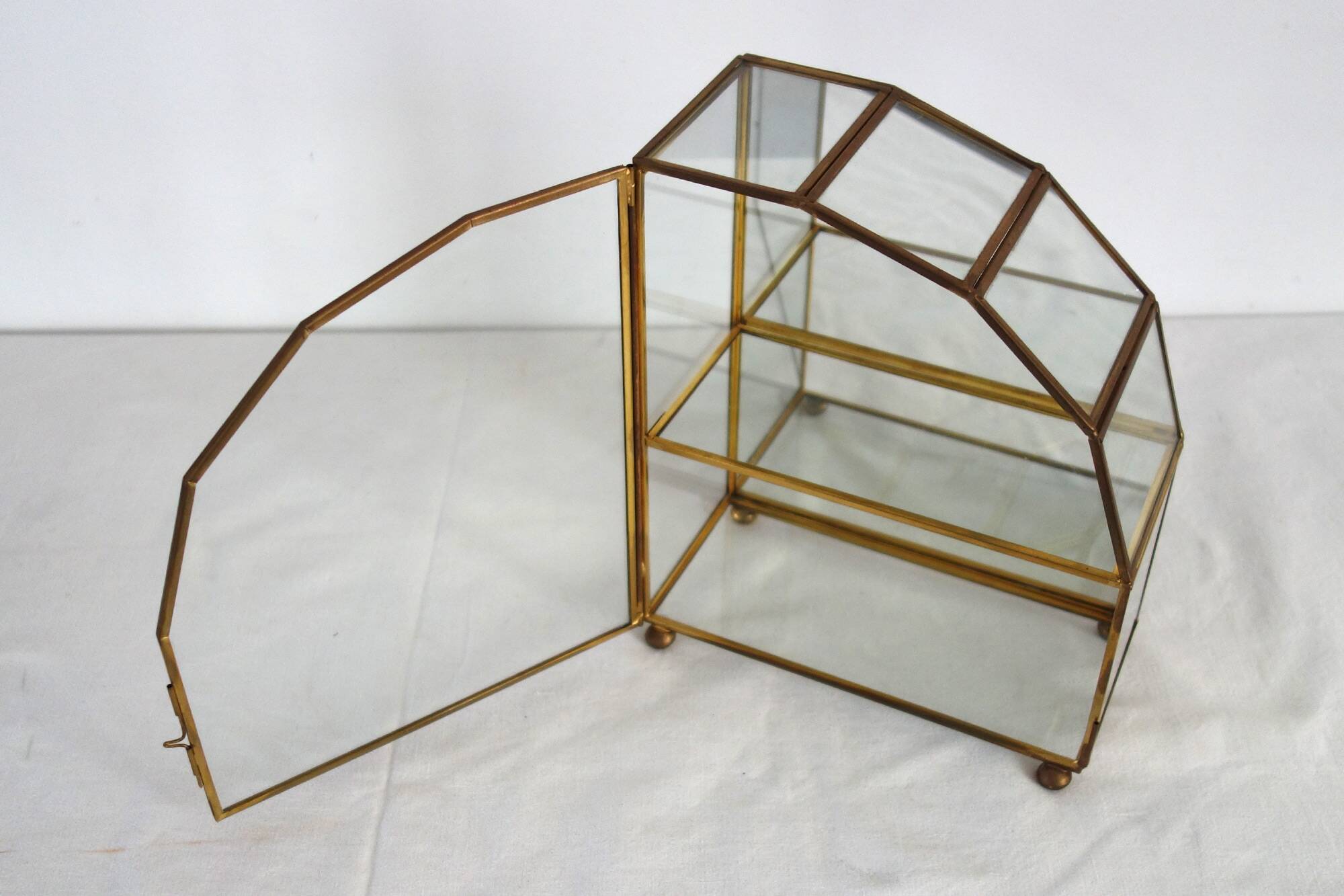 Pair of gilded brass, glass, mirror display cases from the 60s