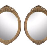 Pair of oval wooden windows with golden patina