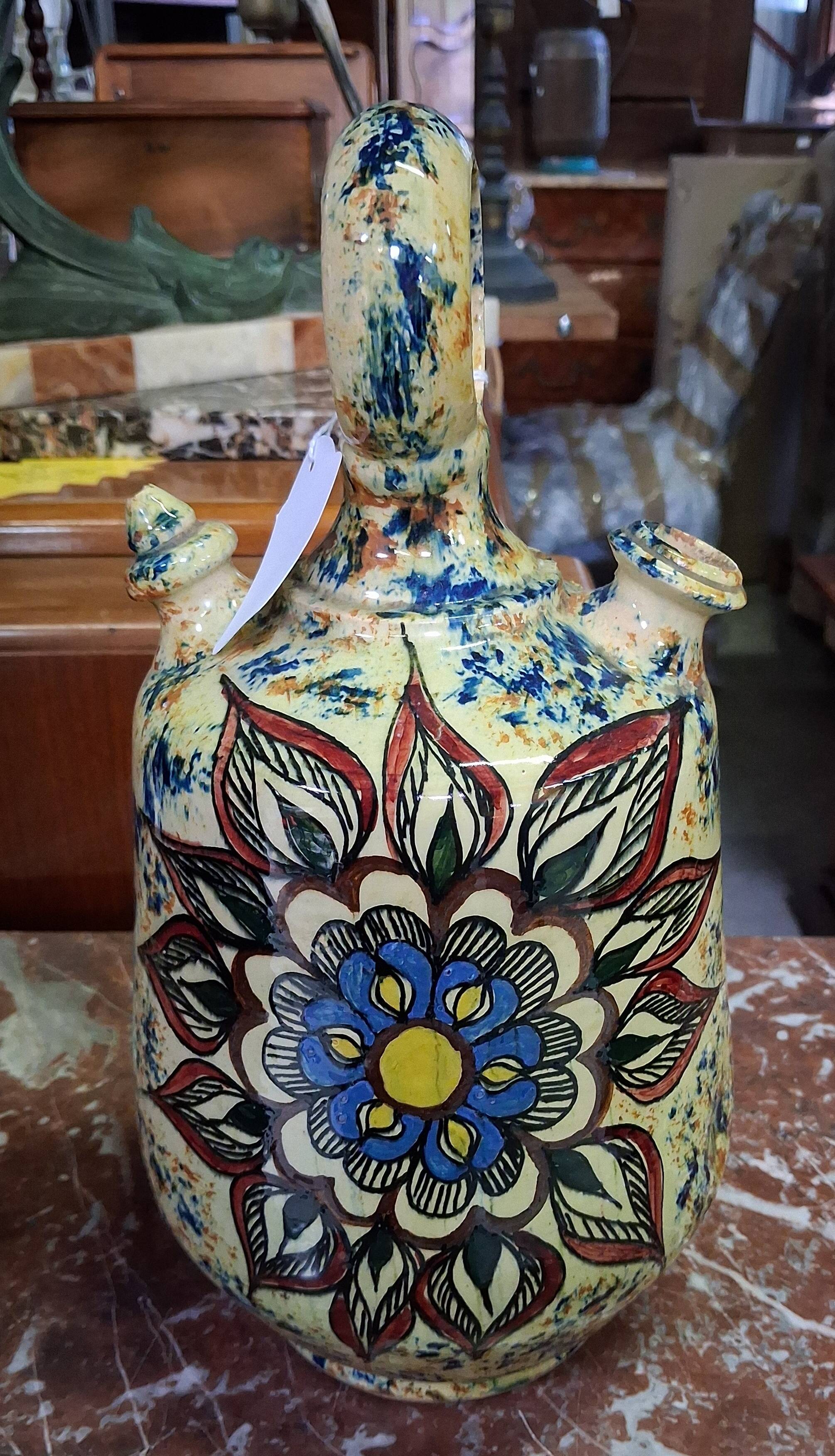polychrome floral-decorated jug in glazed ceramic