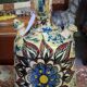 polychrome floral-decorated jug in glazed ceramic